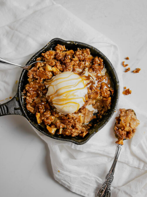 Homemade caramel apple crumble topped with ice cream