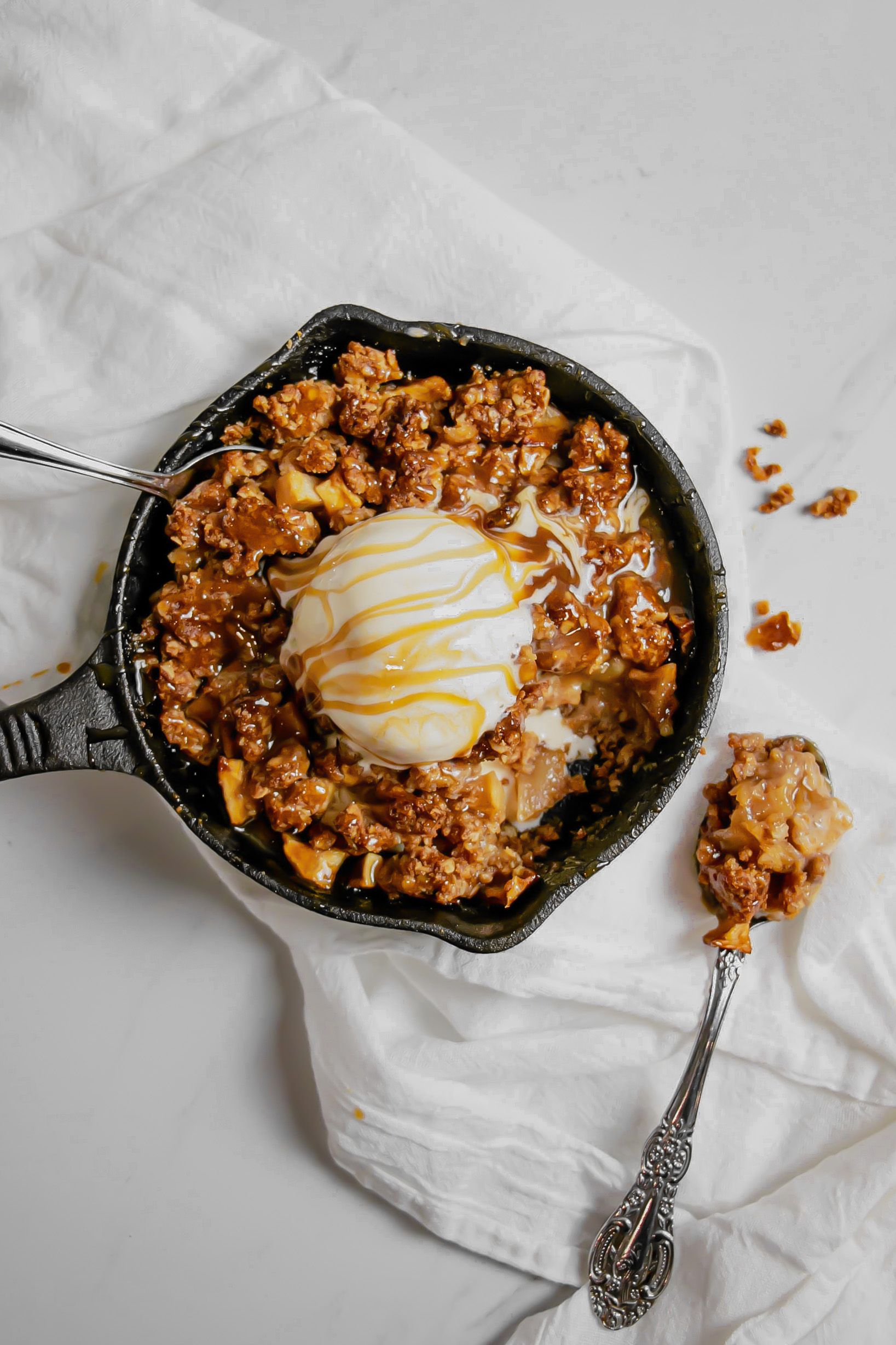 Homemade caramel apple crumble topped with ice cream