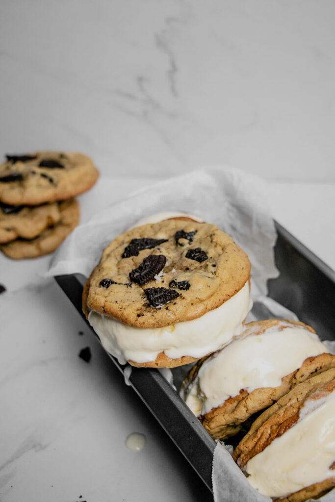 homemade cookies and cream ice cream sandwiches stacked dripping and melting