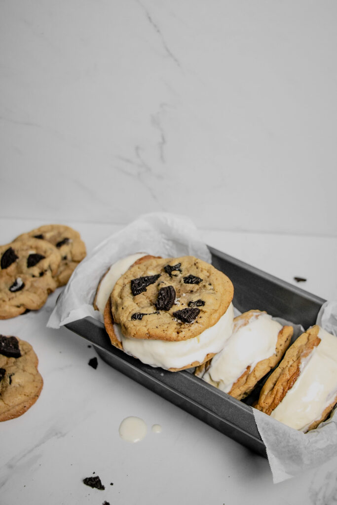 homemade cookies and cream ice cream sandwiches stacked melting