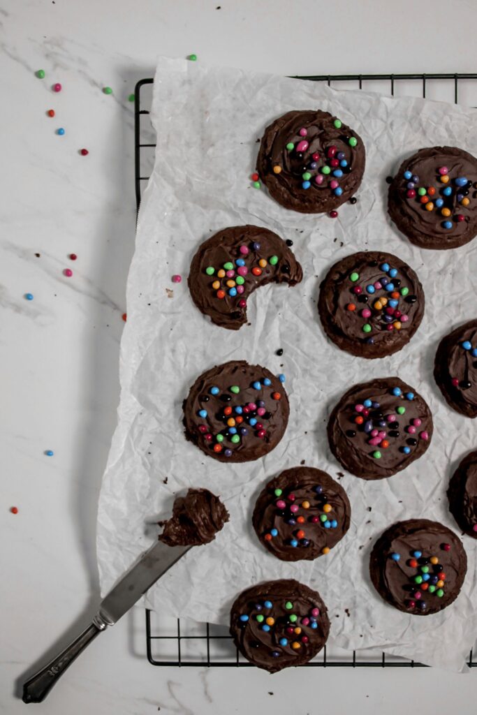 Homemade cosmic brownie cookies lay out decorating