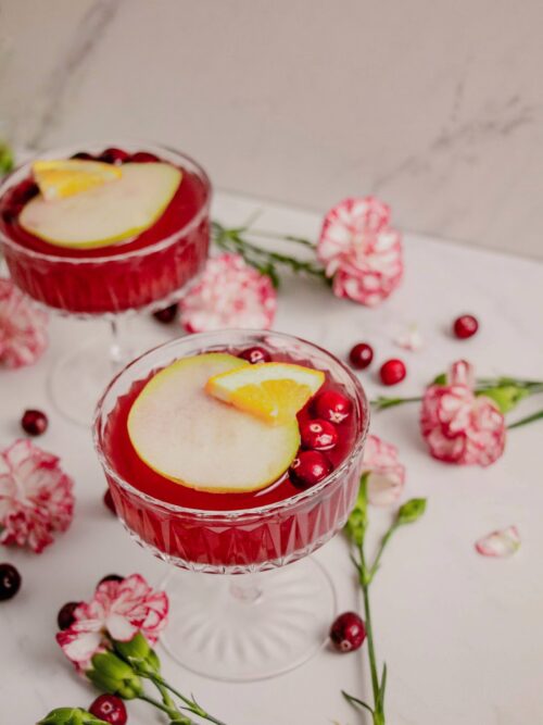 Rosé pear sangrias cocktails in coup glasses with flowers