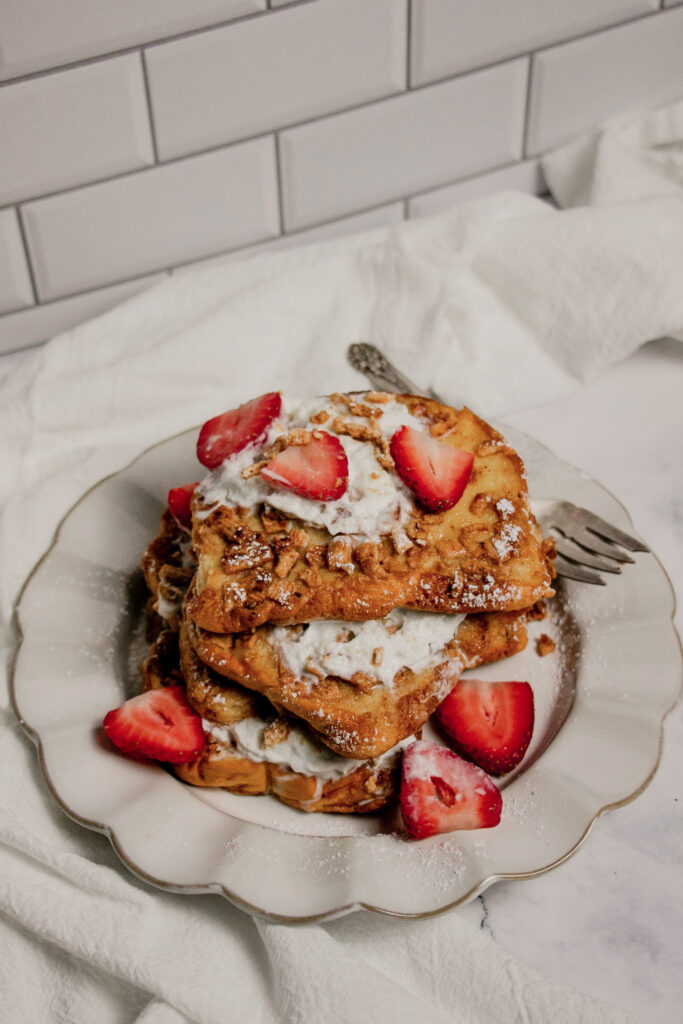 homemade stack of cinnamon toast crunch french toast with strawberries