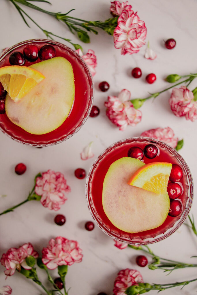 Rosé pear sangrias cocktails in coup glasses with flowers