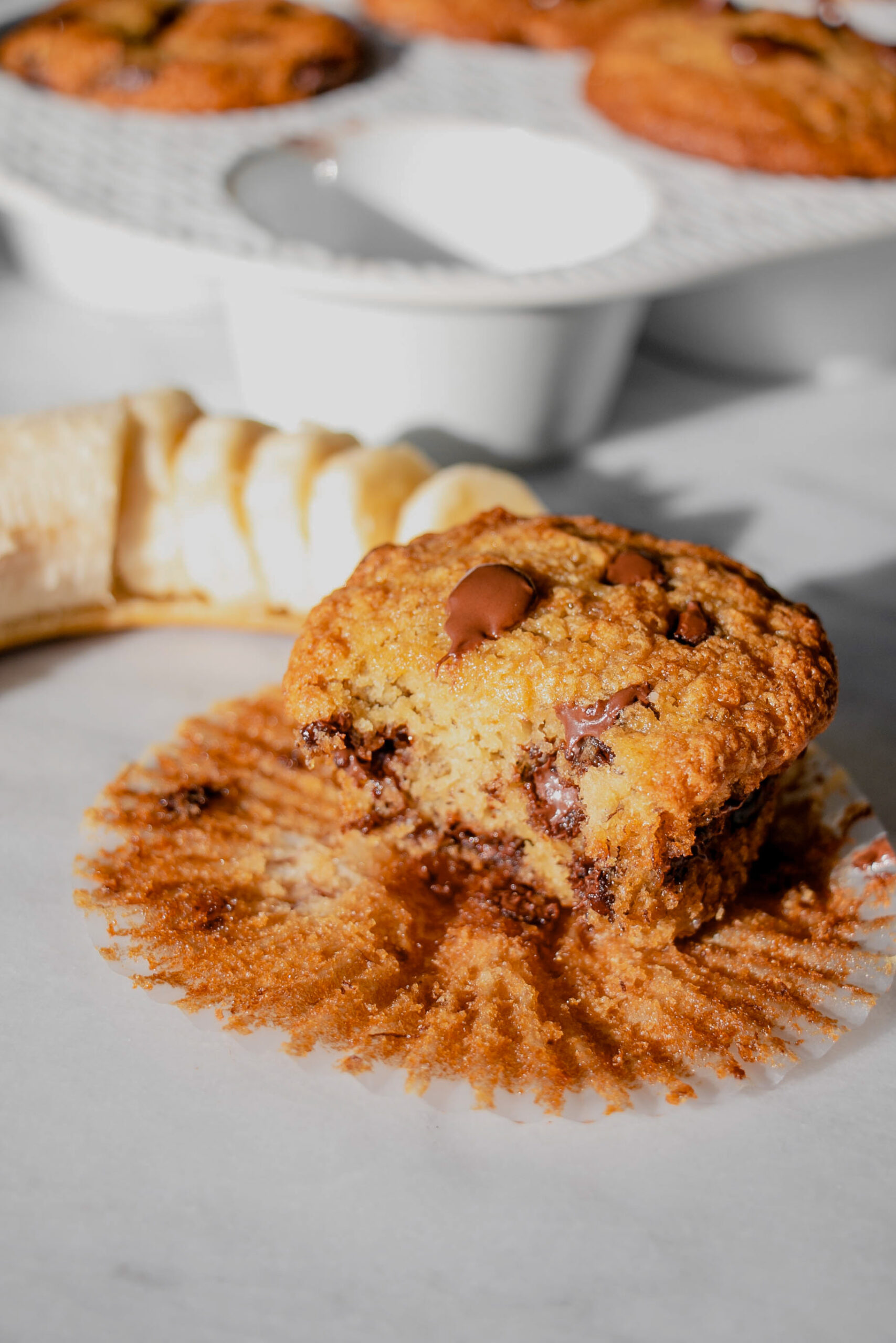 homemade banana chocolate chip muffin with a bite