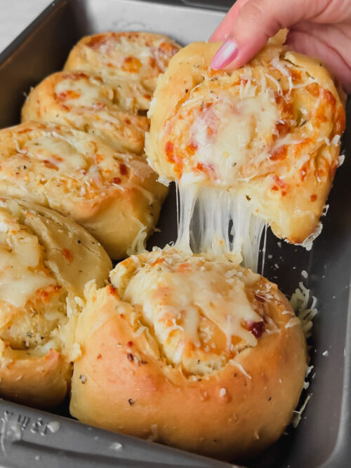 homemade cheesy garlic rolls with a cheese pull