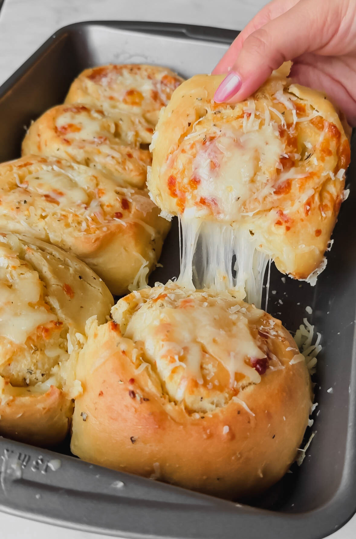 homemade cheesy garlic rolls with a cheese pull