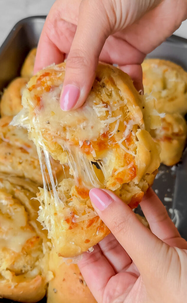 homemade cheesy garlic rolls being pulled apart