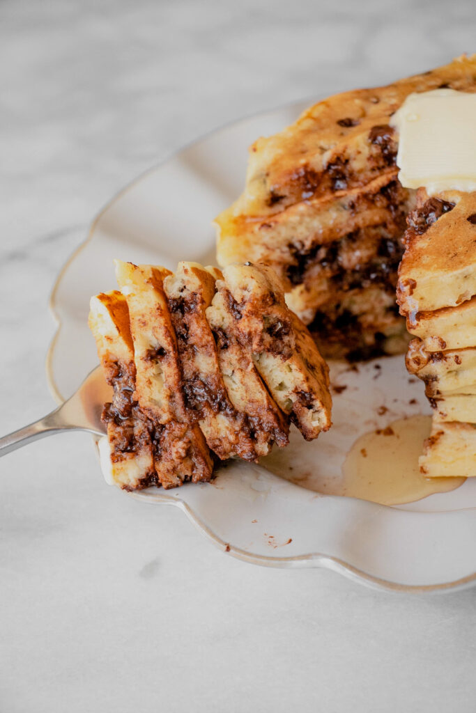 sliced stack of chocolate chip pancakes