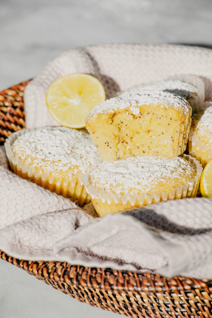 stack of homemade lemon poppy seed muffins in a basket