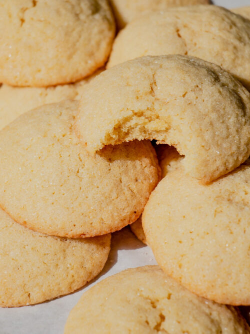 homemade sugar cookies in a pile with a bite