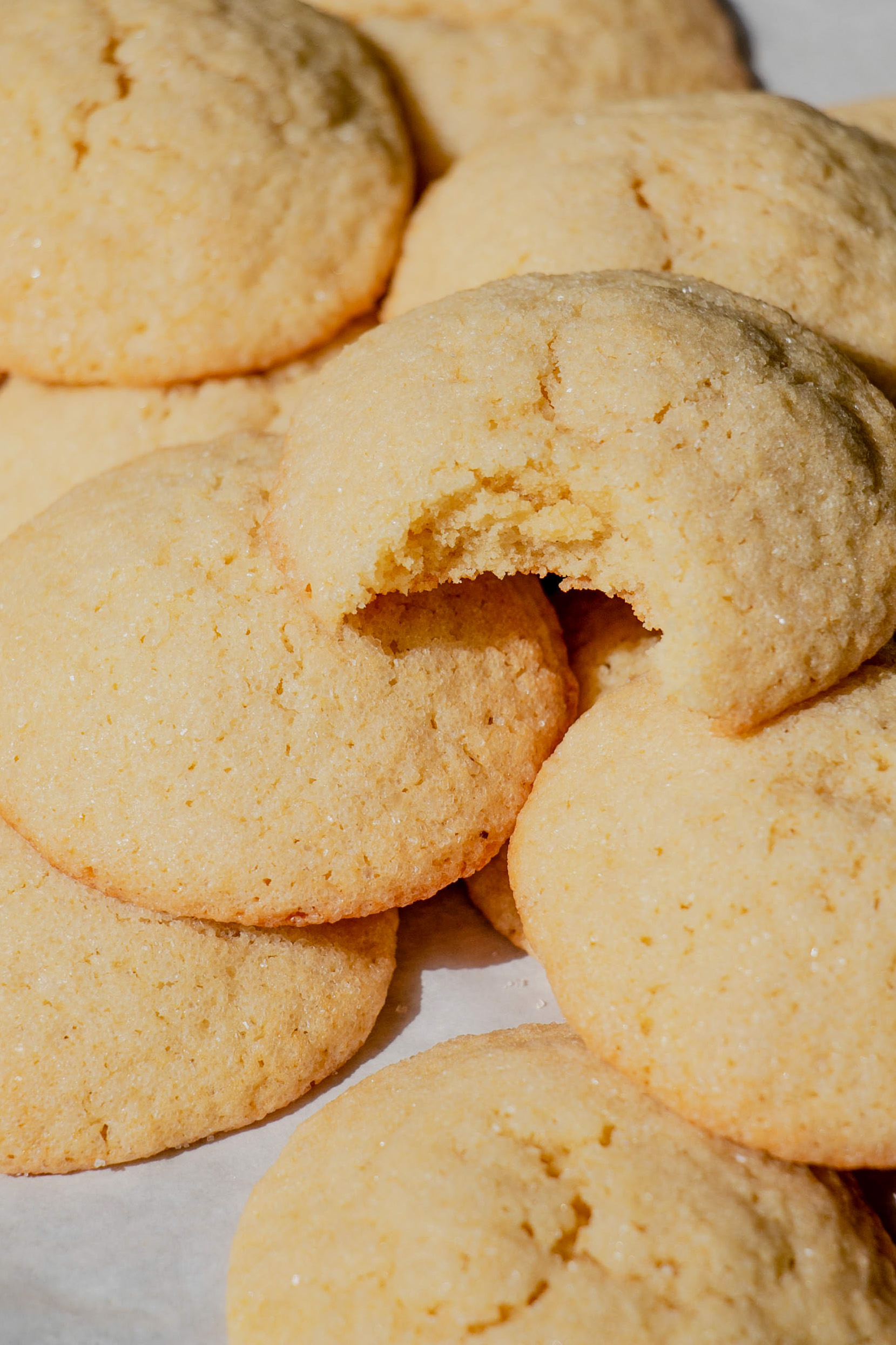 homemade sugar cookies in a pile with a bite