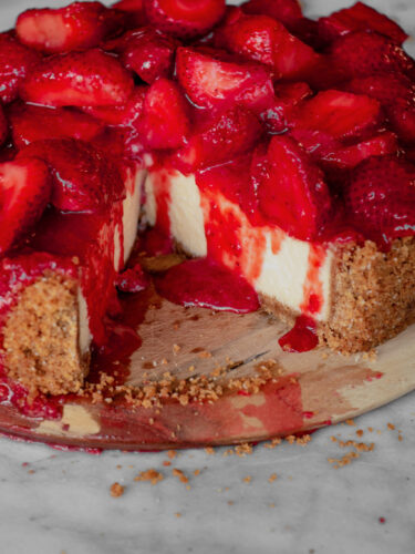 homemade strawberry cheesecake with a slice missing