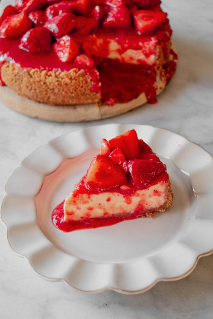 homemade strawberry cheesecake with a slice on the side