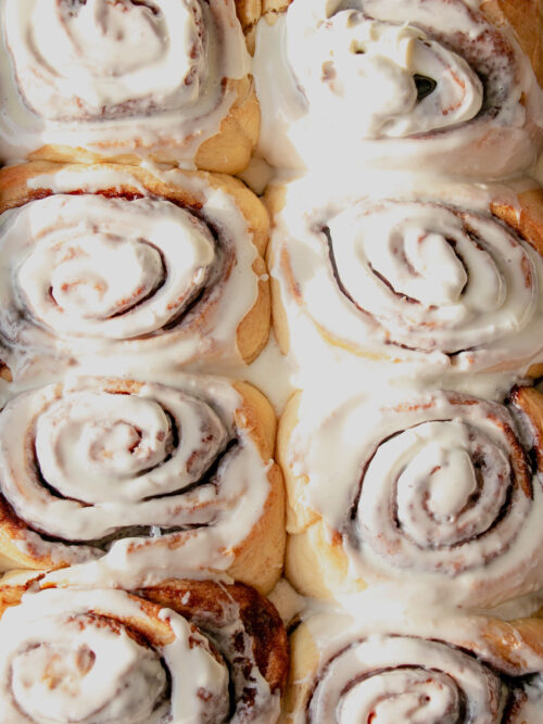 homemade cinnamon rolls frosted top view