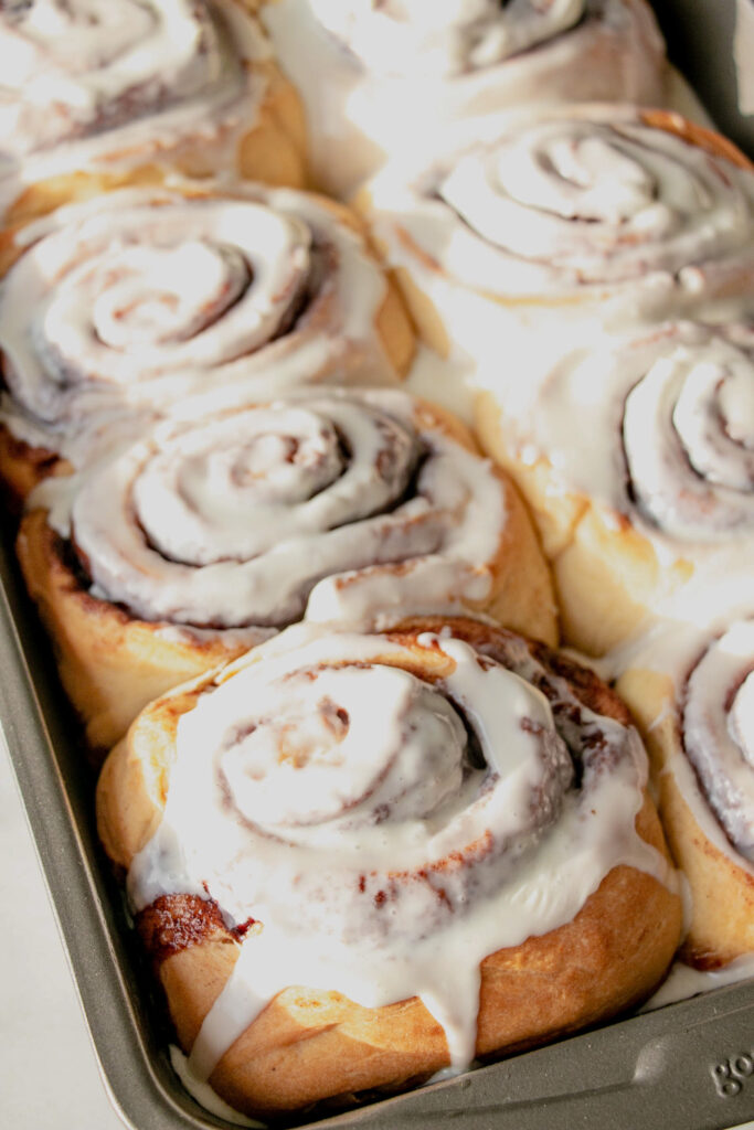 homemade cinnamon rolls frosted in a pan