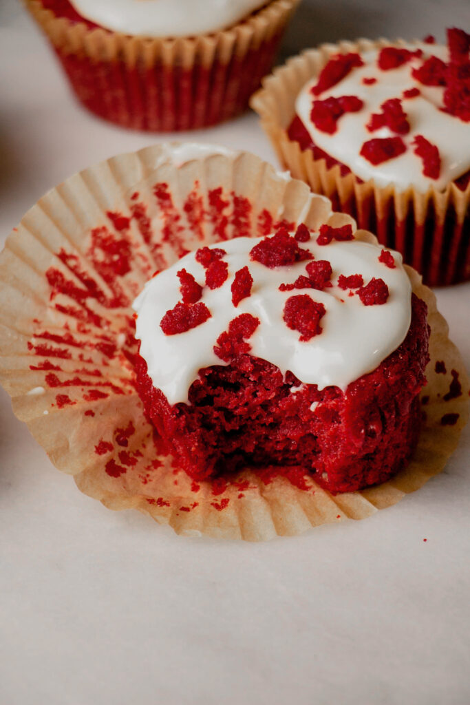 homemade red velvet cupcakes with a bite from the side